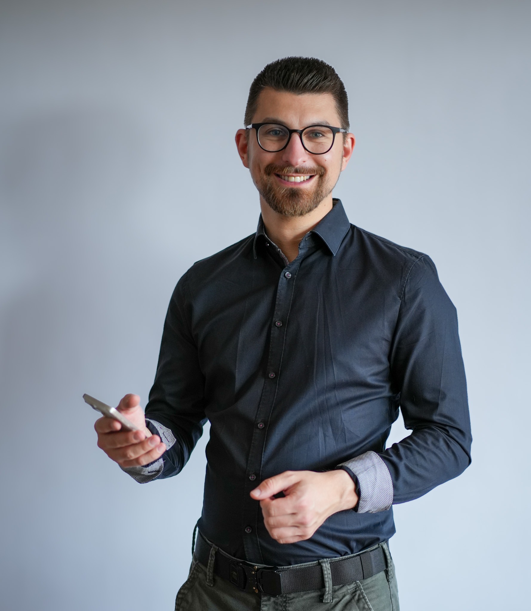 Gene-Joy Wagner mit Smartphone in der Hand im Kontaktbereich